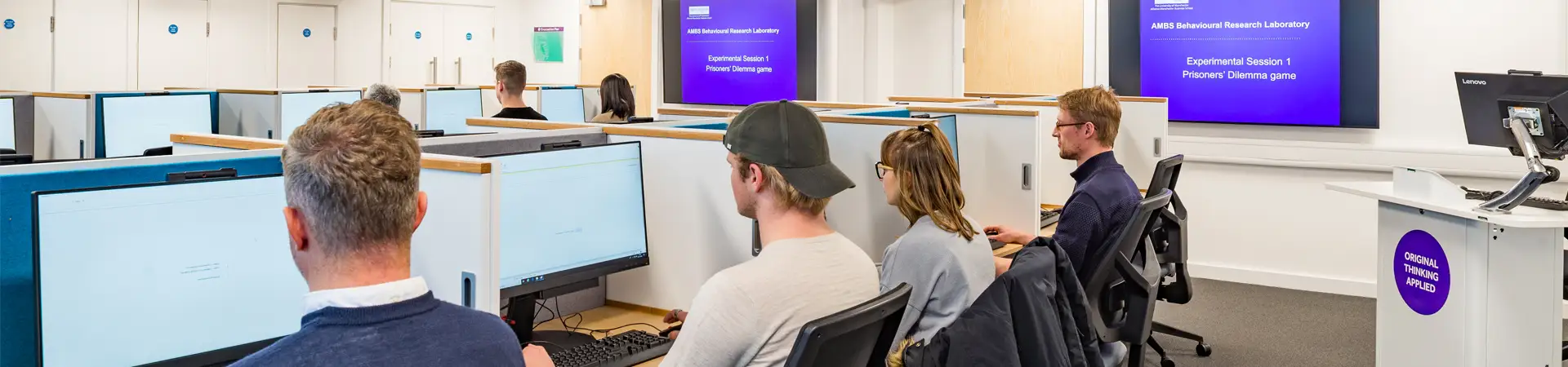 A group of students working at computers in the Behavioural Research Laboratory at AMBS
