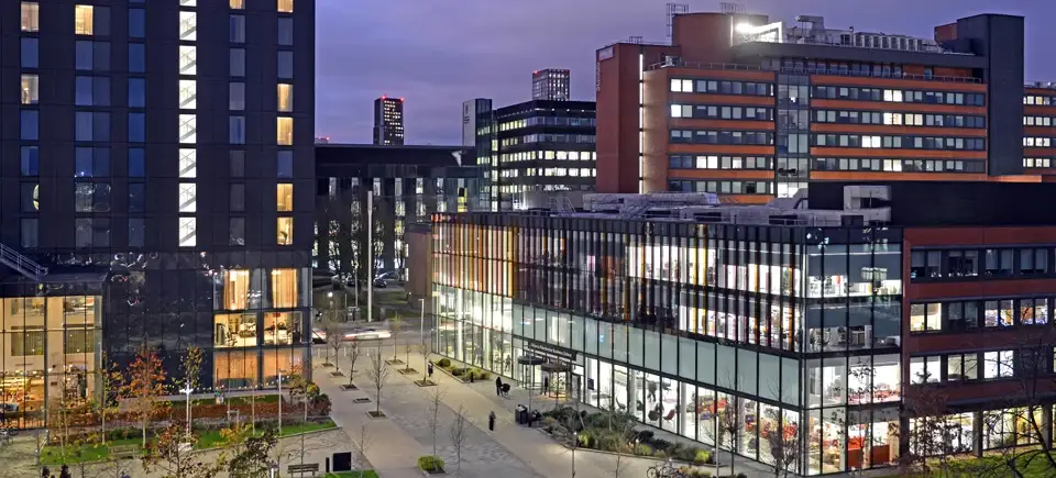 The Alliance Manchester Business School building and Hyatt Hotel on campus in the evening light