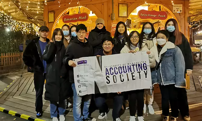 Hoi Kit with his friends in the accounting society at Manchester Christmas markets