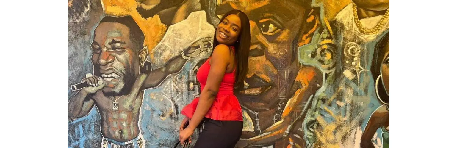 girl in front of mural