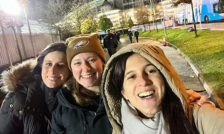 three girls in front of the etihad