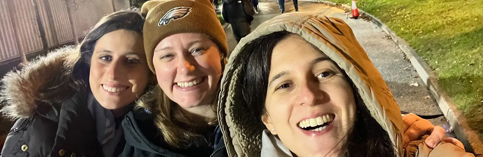 three girls in front of the etihad