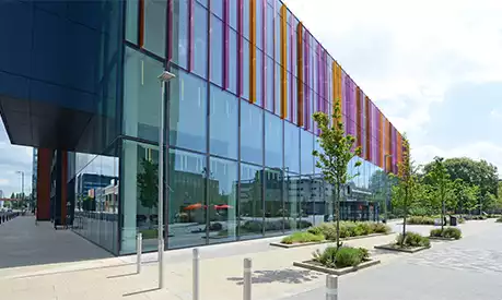 The Alliance Manchester Business School viewed from Booth Street West. The weather is clear and the sun is shining.