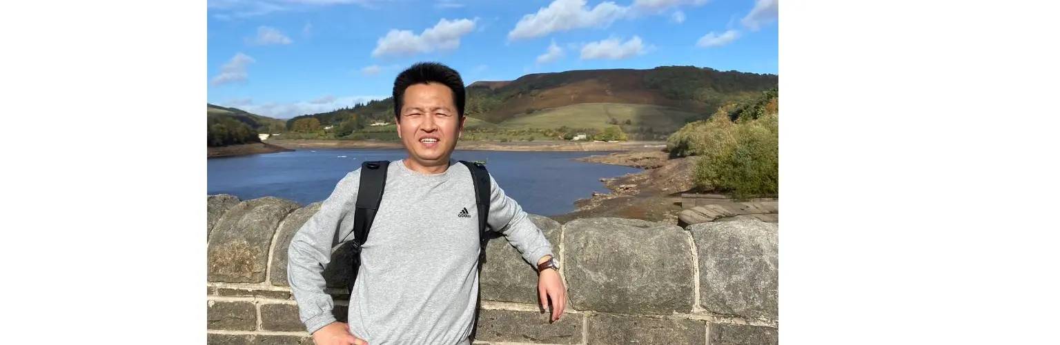 student in front of lake