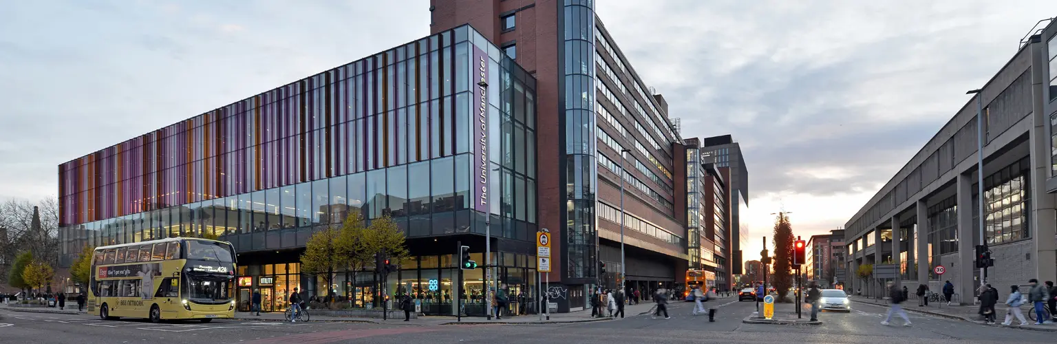 The Alliance Manchester Business School building on the busy Oxford Road in Manchester