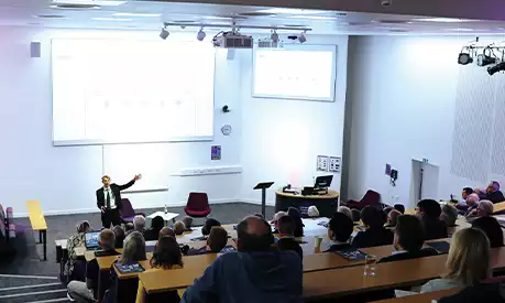 Andy Haldane presenting at a lecture at Alliance Manchester Business School