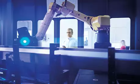 A scientist controlling a robotic arm from a safe distance away.