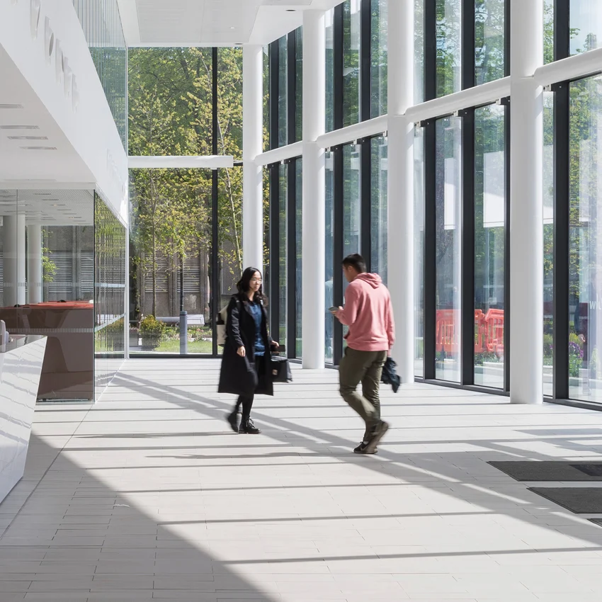 Students walking through the reception at Alliance Manchester Business School