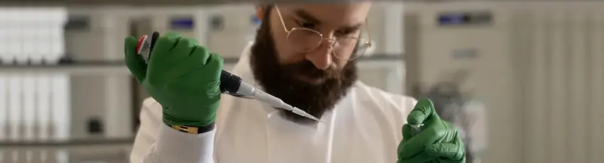 Mohammad El Hajj, CEO of Bright Biotech in a laboratory holding a needle and test tube