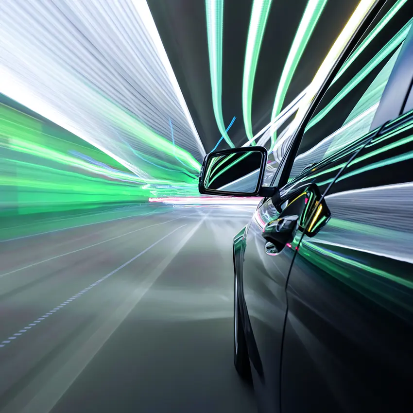 Close up of a car's wing mirror in a tunnel with bright lights