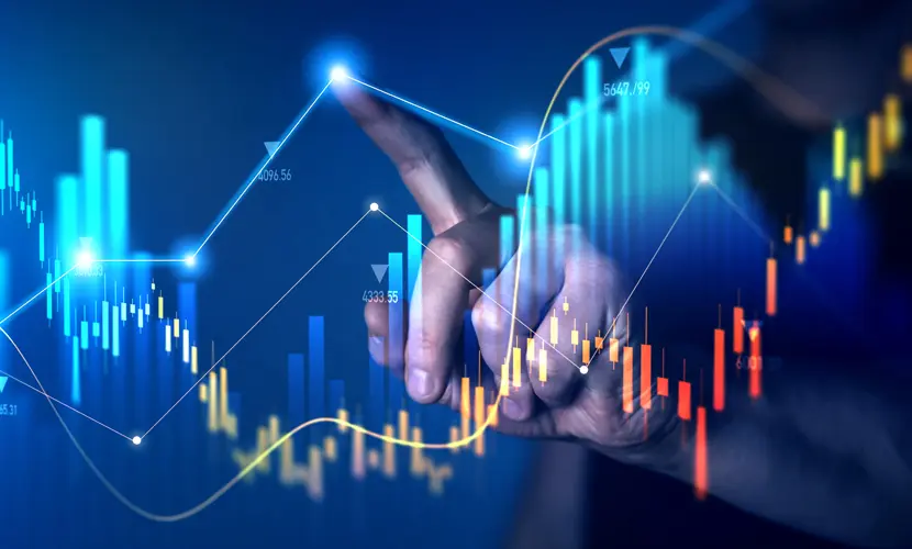 A finger pointing at a graphic of a digital graph.