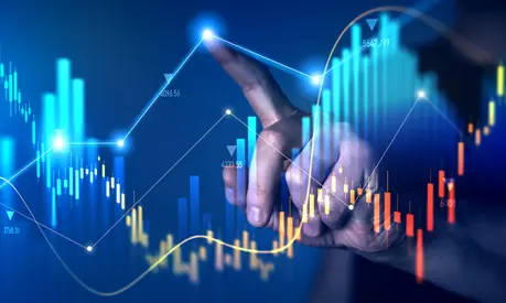 A finger pointing at a graphic of a digital graph.