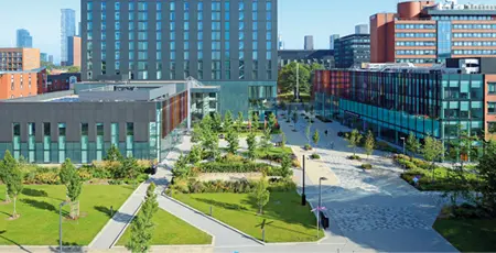 The Alliance Manchester Business School building, Executive Education Centre and Hyatt Hotel on campus in the daylight.