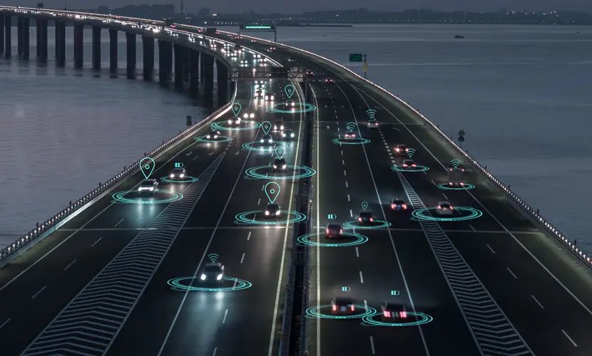 A graphic of cars driving down a motorway with icons above them symbolising the use of technology and AI.
