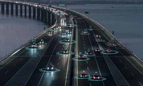 A graphic of cars driving down a motorway with icons above them symbolising the use of technology and AI.