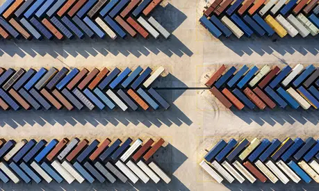 Aerial view of a distribution warehouse with truck and containers and road
