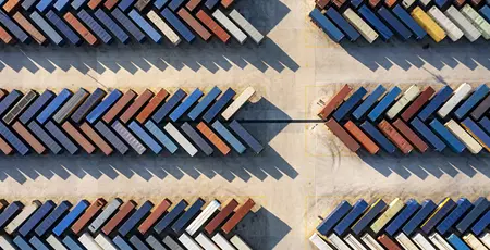 Aerial view of a distribution warehouse with truck and containers and road