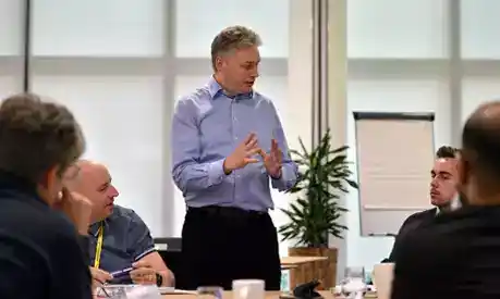 A man addressing a group of executives