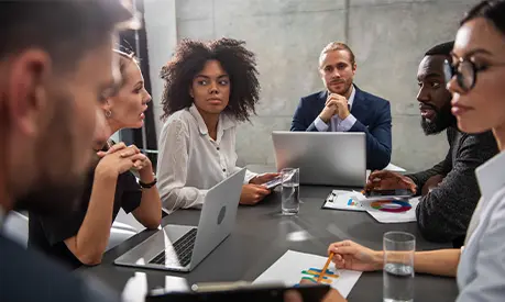 Colleagues sitting around a meeting table