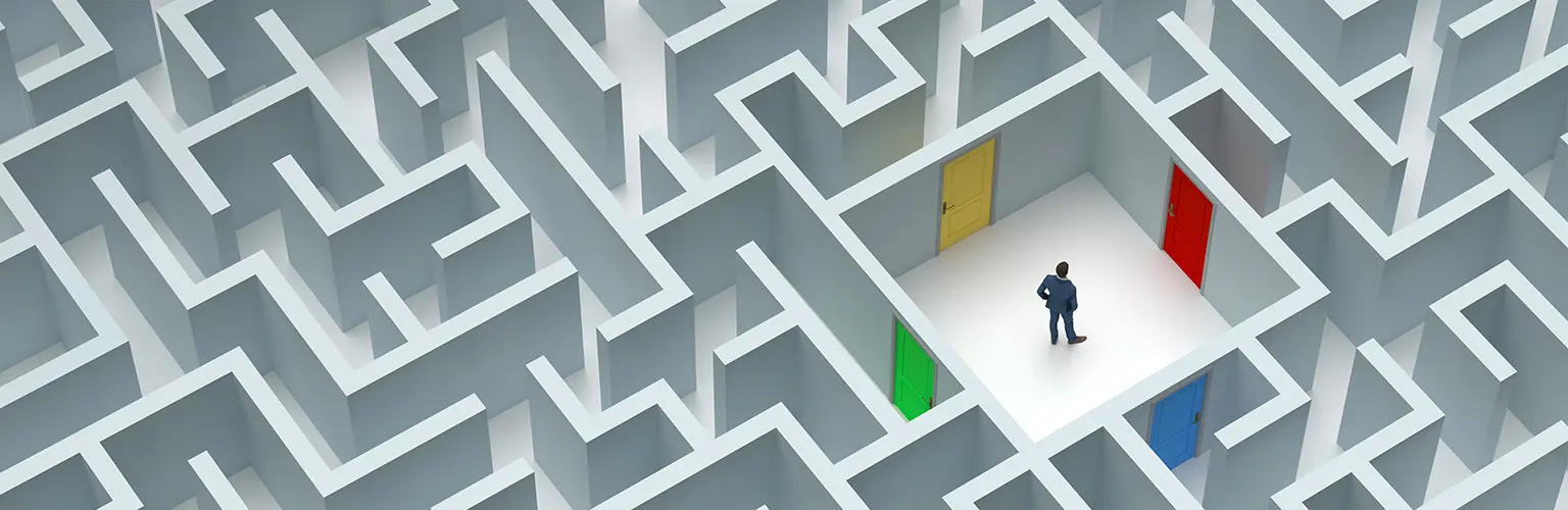Man stood in the middle of a maze deciding which of four coloured doors to walk through