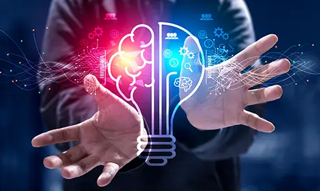 A pair of male hands surrounding an image of a glowing lightbulb