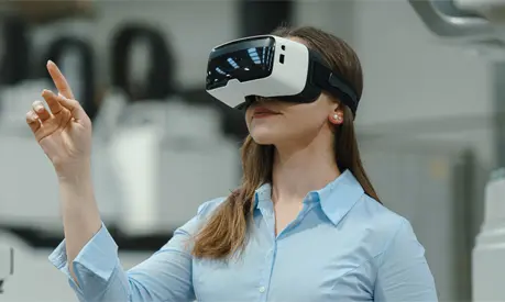 A woman engineer using a VR headset in a modern industrial factory.
